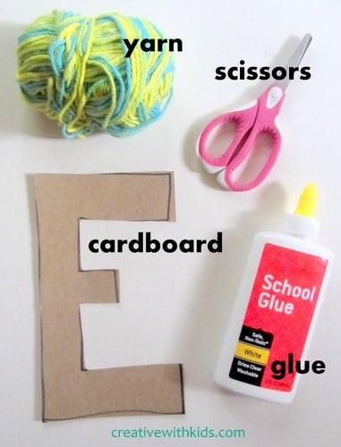 Covering cardboard letters with yarn